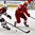GRAND FORKS, NORTH DAKOTA - APRIL 22: Latvia's Roberts Blugers #21 skates with the puck while Denmark's Nikolaj Krag #11 defends during relegation round action at the 2016 IIHF Ice Hockey U18 World Championship. (Photo by Matt Zambonin/HHOF-IIHF Images)


